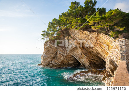 Coast landscape with rocks, sea and vegetation near ancient fort in Petrovac, Montenegro in winter time. Coast landscape with rocks, sea and vegetation near ancient fort in Petrovac, Montenegro in winter time. 123971150