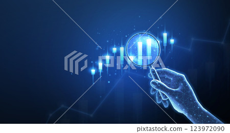 Hand with magnifying glass and stock chart Hand with magnifying glass and stock chart 123972090
