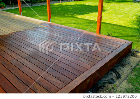 Close-up of a wooden deck - on the covered terrace - showing the process of restoration 123972200