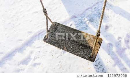 Close-up of a wooden swing with a light layer of frost 123972966