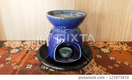 Soothing Aromatherapy Blue Ceramic Warmer with Candlelight on the display 123973658