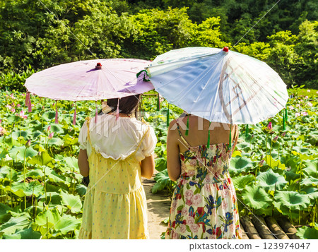 Two young girls with colourful umbrellas in Yangshuo, China 123974047