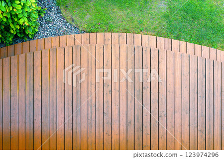 garden terrace made of exotic wood, cleaned with a high-pressure washer and oiled - condition after conservation and renovation of the wooden surface 123974296