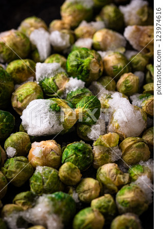Frozen Brussels sprouts on dark background Frozen Brussels sprouts on dark background 123974616