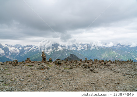Stone Cairns Stand Tall Against a Backdrop of Majestic Mountain Ranges Stone Cairns Stand Tall Against a Backdrop of Majestic Mountain Ranges 123974849