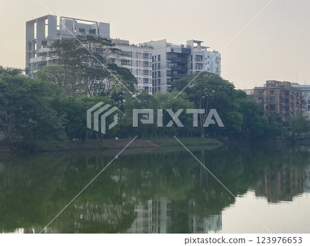 An apartment building near a lake in Dhaka, Bangladesh, a developing country overseas 123976653