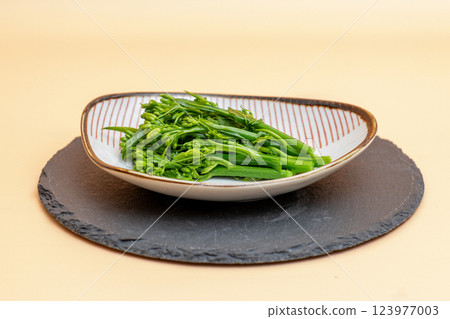 A dish of rape blossoms on a small plate - stock photo of the taste of spring A dish of rape blossoms on a small plate - stock photo of the taste of spring 123977003