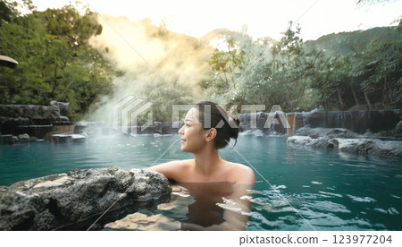 A young woman taking a leisurely open-air bath A young woman taking a leisurely open-air bath 123977204