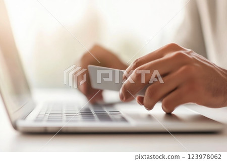 Hands entering sensitive payment information for an online purchase 123978062