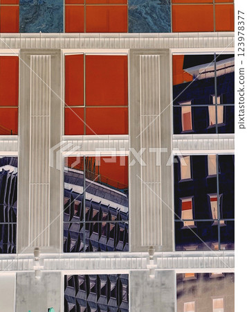 Glass facade of multi-storey office building with reflection of the city in the windows. Creative art collage for poster with city view. House wall. Glass facade of multi-storey office building with reflection of the city in the windows. Creative art collage for poster with city view. House wall. 123978377