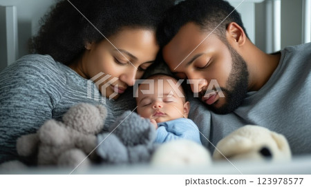 Parents Comfortably Watching Their Infant Sleeping in Crib Parents Comfortably Watching Their Infant Sleeping in Crib 123978577