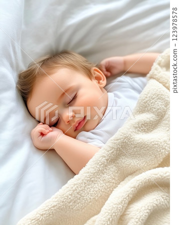 A serene newborn sleeping peacefully in a cozy crib 123978578