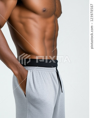 Athletic man executing abdominal crunch workout for six-pack abs 123978587