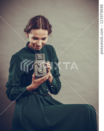 Woman retro style with old camera Woman retro style with old camera 123978686