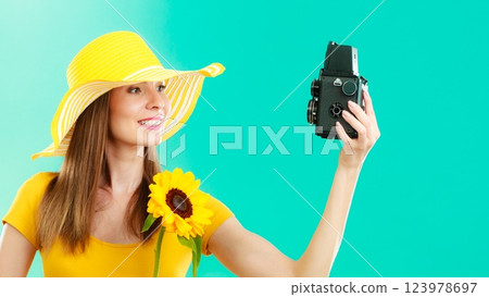 Summer woman holds sunflower old camera Summer woman holds sunflower old camera 123978697