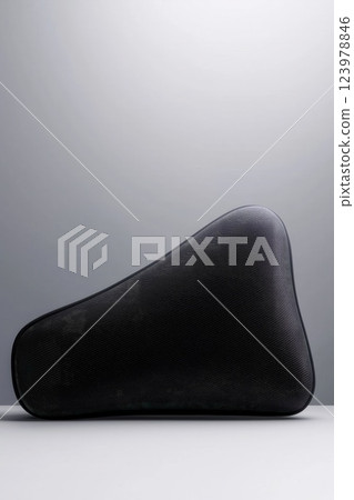Ergonomic Memory Foam Travel Pillow in Dark Fabric Texture Perfect for Comfortable Journeys Isolated on White Background 123978846