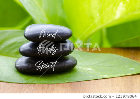 Mind Body and Spirit ext on black zen stones. Inner peace and zen concept 123979064