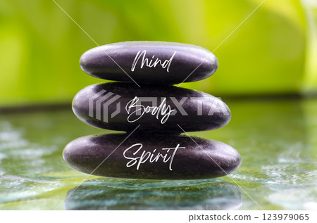 Mind Body and Spirit ext on black zen stones. Inner peace concept Mind Body and Spirit ext on black zen stones. Inner peace concept 123979065