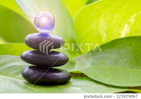 Blue shining glass marble on top zen stones with customizable space for text 123979067