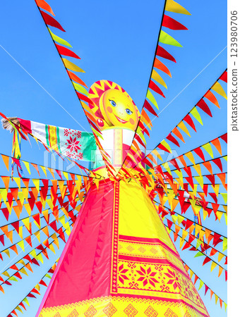 Shrovetide in Russia. Big doll for the burning on the blue sky background Shrovetide in Russia. Big doll for the burning on the blue sky background 123980706