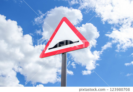 Triangle speed bump road sign against the blue sky Triangle speed bump road sign against the blue sky 123980708