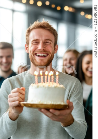 Modern Office Birthday Celebration with Cake in Hand 123980993