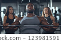 Powerful workout athlete lifting heavy weight gym, athlete strength visualizing physical perfection, intense group supportive workout surrounding motivated athlete, determination workout. 123981591