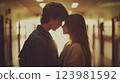 Romance couple gently touching foreheads, romance portrayed in soft light, beautiful moment full of emotions, two young people expressing tender feelings, concept showing romance intimacy. 123981592