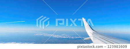 Contrails stretching through bright blue sky Contrails stretching through bright blue sky 123981609