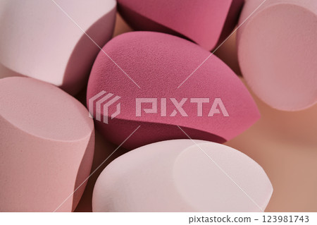 A set of makeup sponges on a pink background. A set of makeup sponges on a pink background. 123981743
