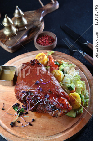 Pork knuckle baked with potatoes and spices. An appetizer for beer. German cuisine. Oktoberfest menu. Oktoberfest menu. Pork knuckle baked with potatoes and spices. An appetizer for beer. German cuisine. Oktoberfest menu. Oktoberfest menu. 123981765