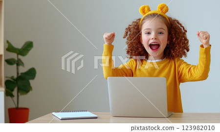 Child with Laptop Focused on Learning 123982010