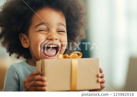 Child excitedly opening gift box 123982018