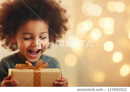 Excited child holding up surprise gift Excited child holding up surprise gift 123982022