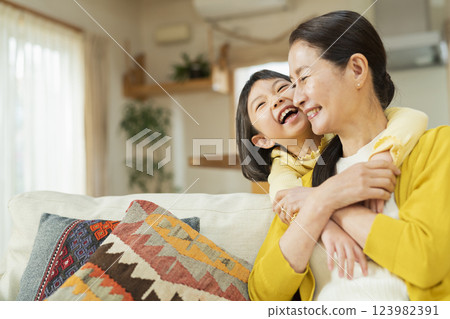 Grandmother spending time with her grandchild in the living room Grandmother spending time with her grandchild in the living room 123982391