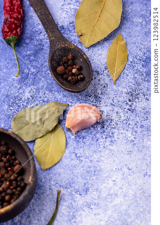 Culinary background with pepper, bay leaf and garlic Culinary background with pepper, bay leaf and garlic 123982514