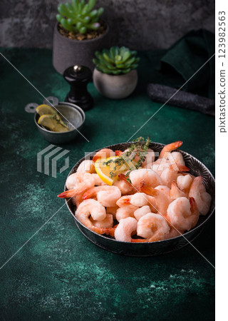 Frozen uncooked prawns or shrimps with lemon Frozen uncooked prawns or shrimps with lemon 123982563
