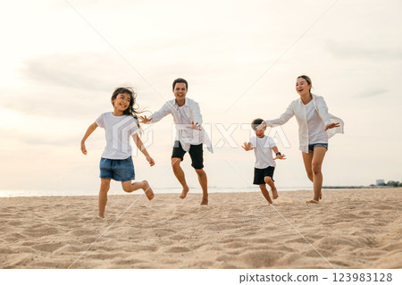 Cheerful family with happy parents and children running on the beach. Summer holiday joy captured in a snapshot of laughter play and smiles. Carefree moments of family bonding and relaxation. Cheerful family with happy parents and children running on the beach. Summer holiday joy captured in a snapshot of laughter play and smiles. Carefree moments of family bonding and relaxation. 123983128