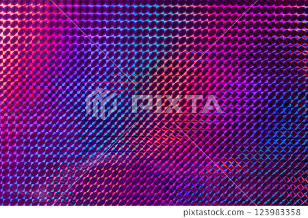 A vibrant, textured surface featuring a mesmerizing blend of purple, pink, and blue hues, reflecting light in a geometric pattern. 123983358