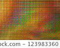 A vibrant, multicolored holographic surface featuring a pattern of raised diamond shapes, reflecting light and creating a dynamic visual effect. 123983360