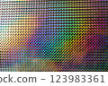 A vibrant, iridescent pattern of diamond shapes reflecting various colors, creating a mesmerizing visual effect reminiscent of art and design. 123983361