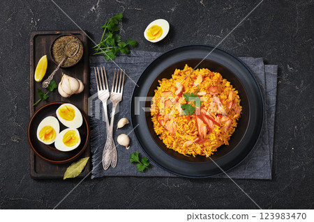 hot smoked salmon kedgeree in a black bowl 123983470