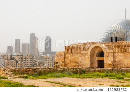 The Dome of Umayyad Palace mosque with city downtown skyline in the background, Citadel Hill, Jabal al-Qala, Amman, Jordan. 123983782