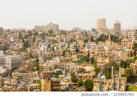 Lots of residential houses densily scattered on the hills in the downtown of Amman city, Kingdom of Jordan 123983783