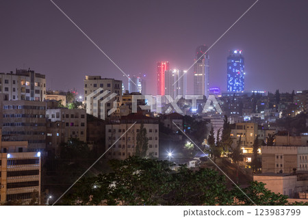 Night panorama of Amman city downtown streets with neon glowing skyscrapers, Kingdom of Jordan 123983799