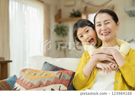 Grandmother spending time with her grandchild in the living room 123984188