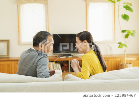 Elderly couple relaxing in the living room Elderly couple relaxing in the living room 123984467