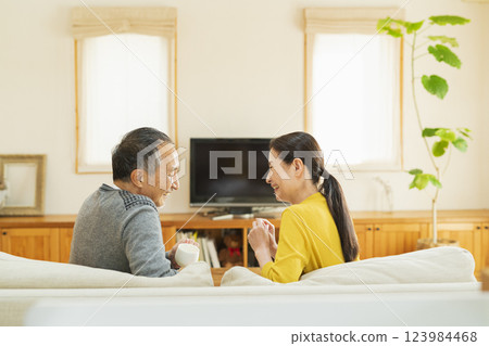 Elderly couple relaxing in the living room Elderly couple relaxing in the living room 123984468