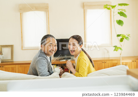 Elderly couple relaxing in the living room Elderly couple relaxing in the living room 123984469