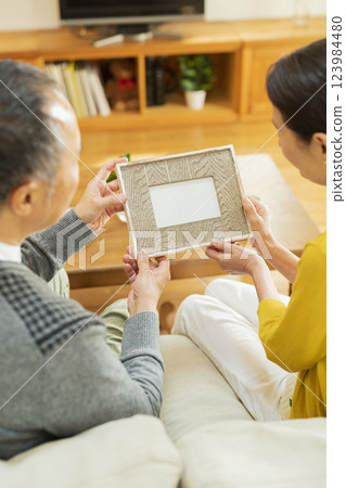 elderly couple looking at photos elderly couple looking at photos 123984480